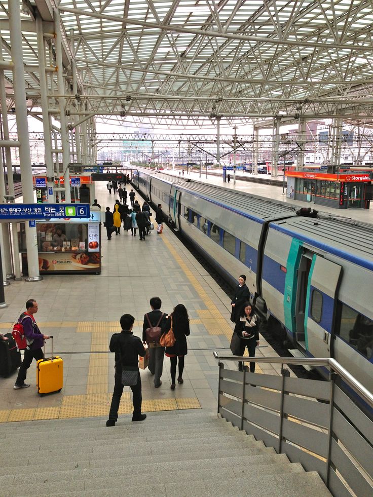 A Seoul subway train arriving at a brightly lit platform