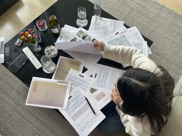 A handwritten research plan and notes on a desk