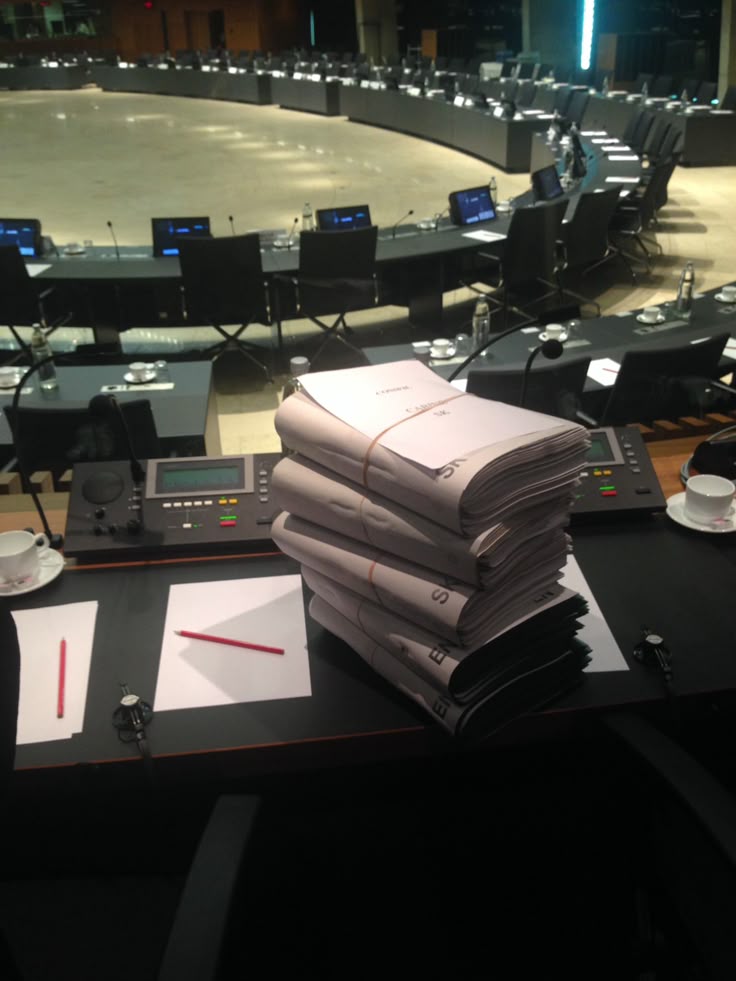 A stack of documents and forms organized on a desk