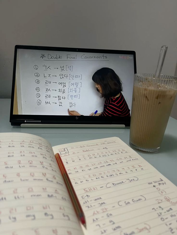 An open dictionary and study notes on a desk